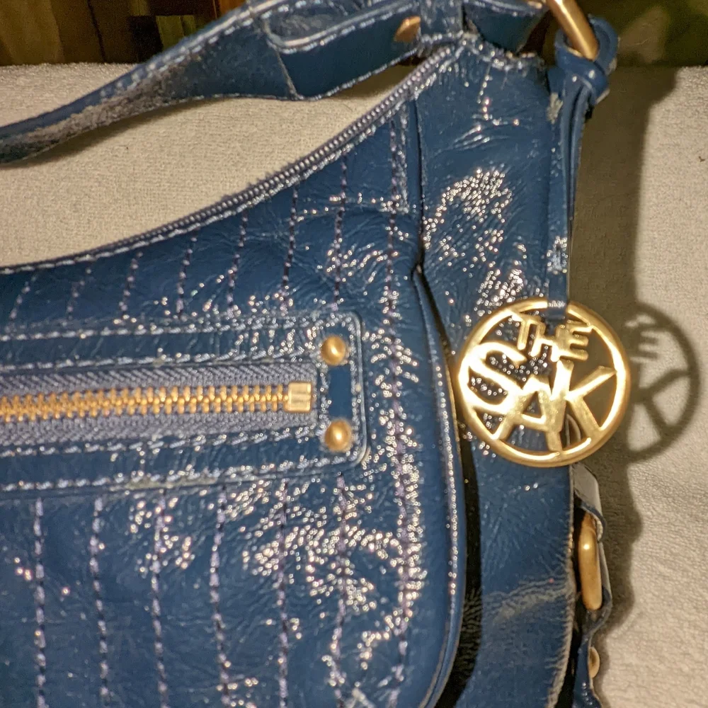 The  Sak navy blue patent leather hobo bag.